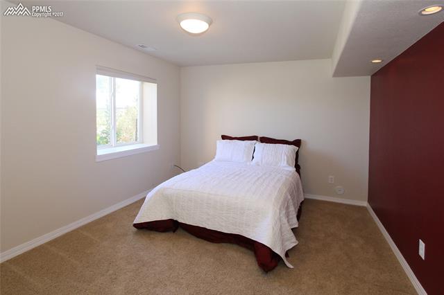 12010 Rio Secco Road Peyton, CO 80831 - Photo 23 of 36 Bedroom #5 located in the basement is light and bright. Additional recessed lighting