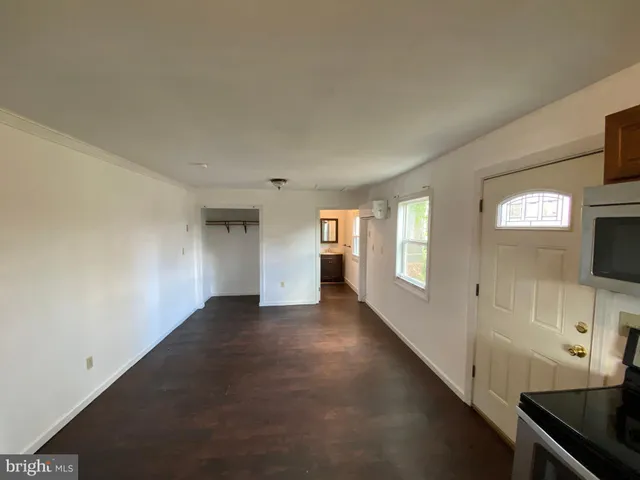 a view of a livingroom with an empty space and a window
