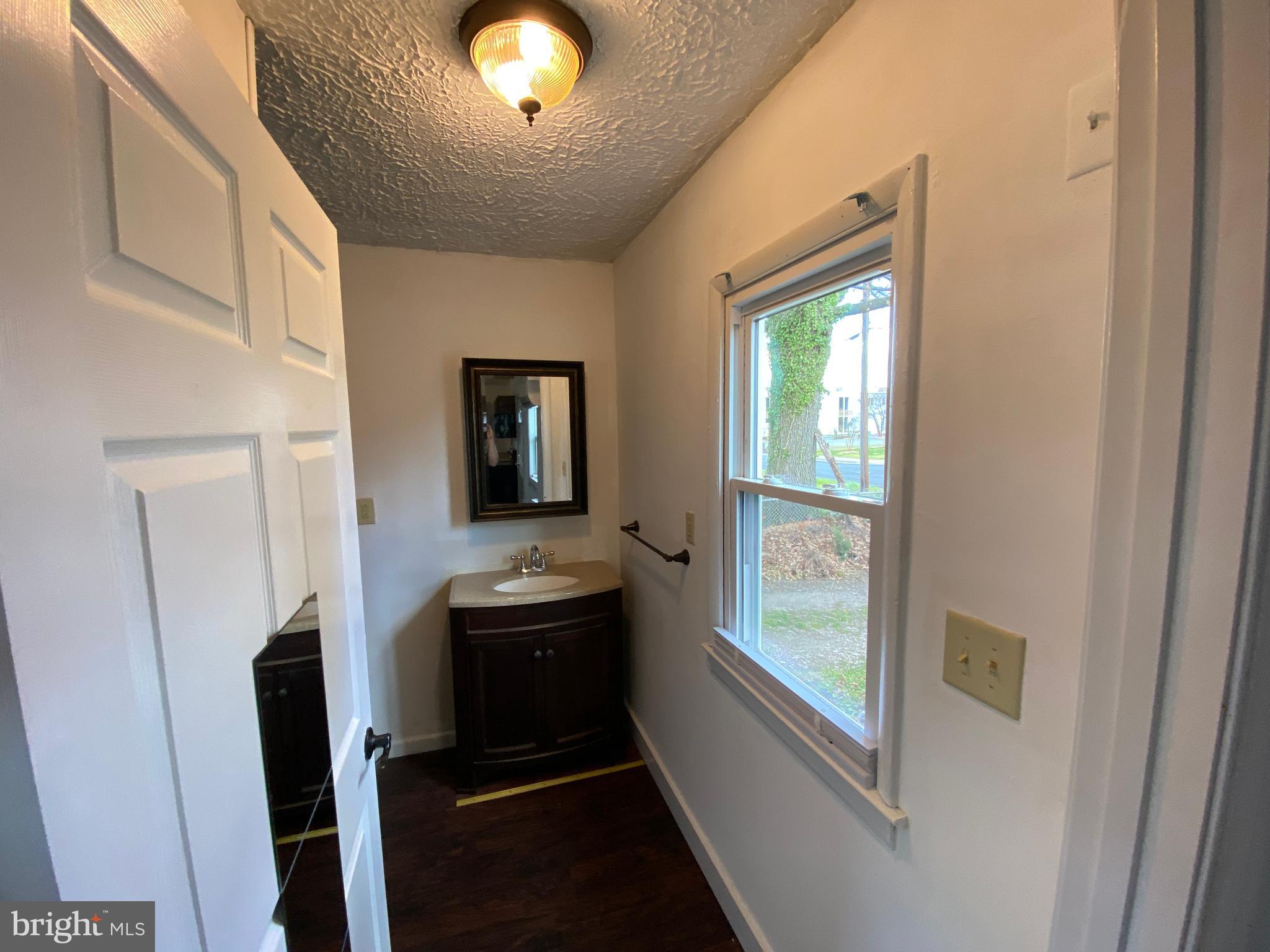 201 North Irving Avenue, Unit B Colonial Beach, VA 22443 - Photo 5 of 8 a view of a hallway and a livingroom with furniture
