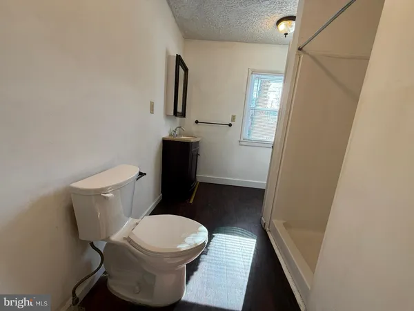 a white toilet sitting next to a sink