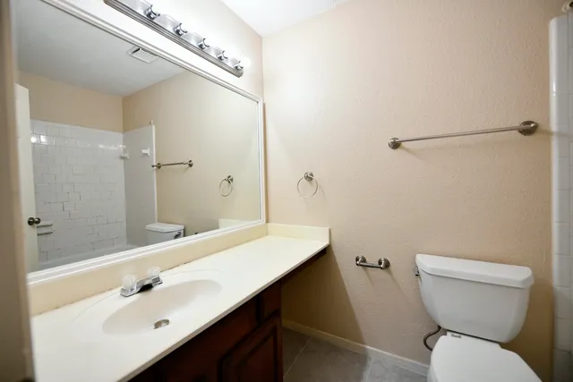 a bathroom with a sink toilet and shower