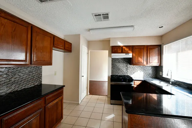 a kitchen with a sink and a stove top oven