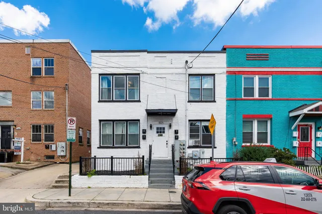 a front view of a building with parking space