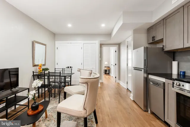 a view of a dining room with furniture a kitchen and chandelier