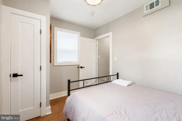 a bedroom with a bed and a window