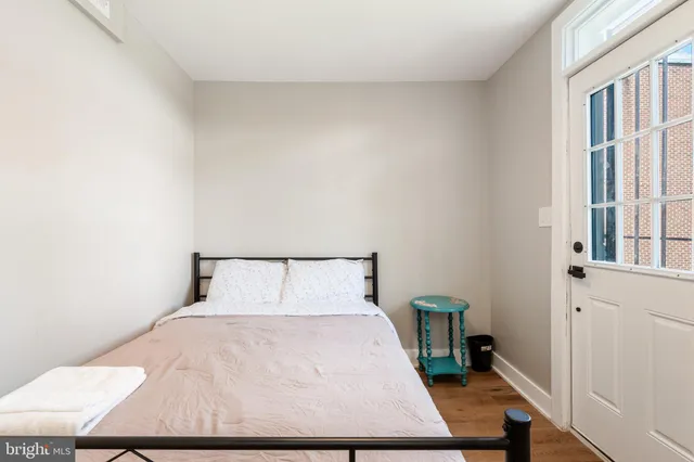 a bed sitting in a bedroom next to a window