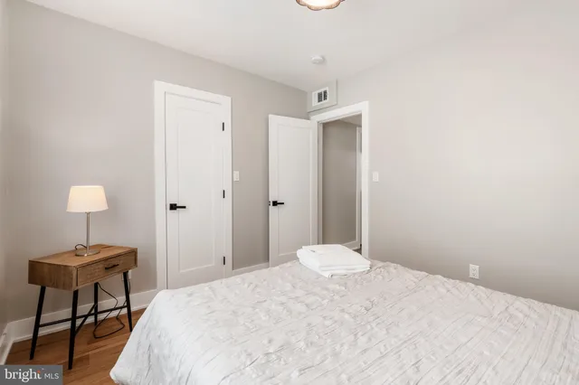a bedroom with a bed and a table