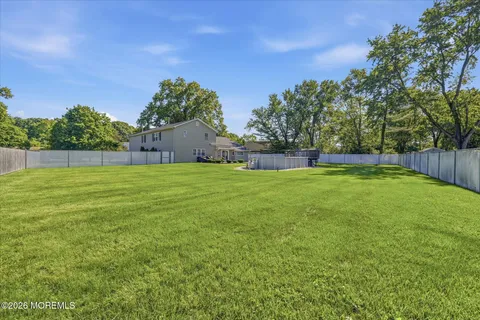 a backyard of a house with lots of green space and mountain view