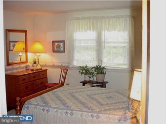 139 Buckwalter Road Pottstown, PA 19465 - Photo 5 of 8 a bed room with a bed and a window