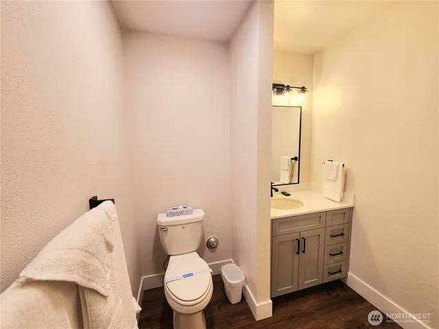 a bathroom with a toilet a sink and mirror