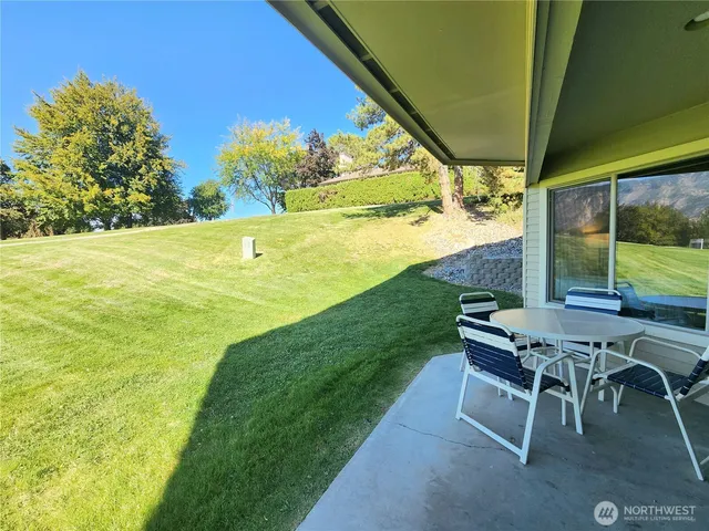 a view of a outdoor kitchen with a table and chairs