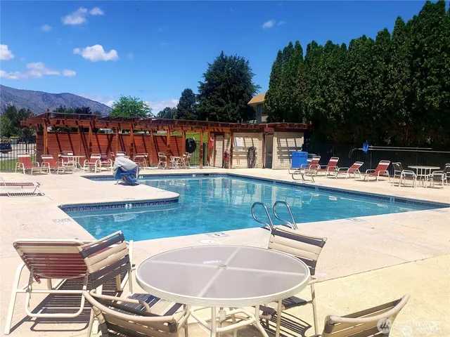 a view of a swimming pool with an outdoor seating