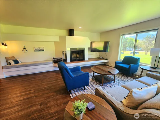 a living room with furniture fireplace and a table