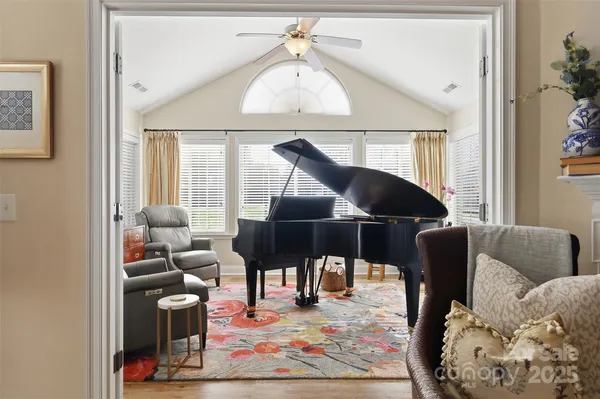 a living room with furniture a rug and a chandelier