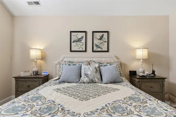 a bedroom with bed and a night stand