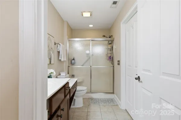 a bathroom with a sink a mirror and a shower