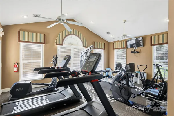 a room with gym equipment and large mirror