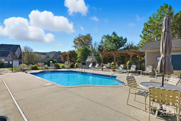 a view of swimming pool with outdoor seating and plants