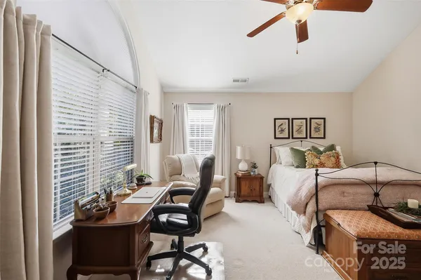 a bedroom with furniture and a potted plant