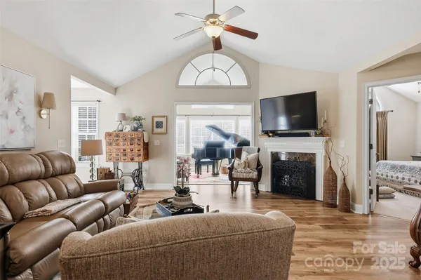 a living room with furniture a fireplace and a flat screen tv