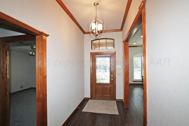 a view of a hallway with wooden floor and stairs