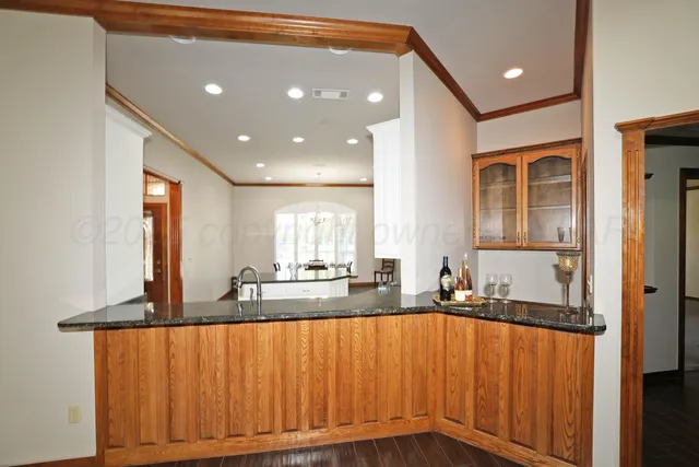 a kitchen with counter top space and windows