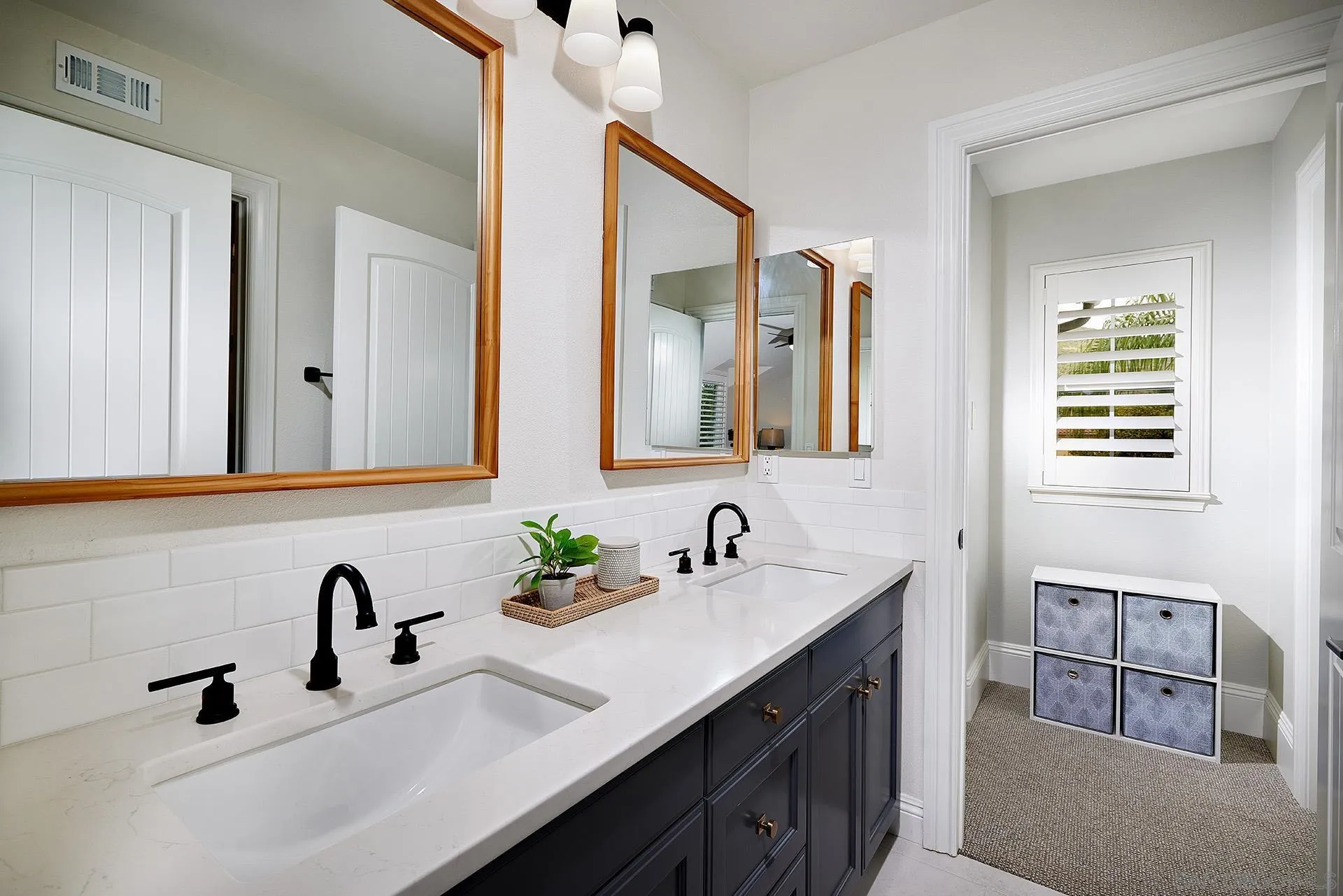 3501 Corte Romero Carlsbad, CA 92009 - Photo 26 of 48 a bathroom with a double vanity sink and a mirror