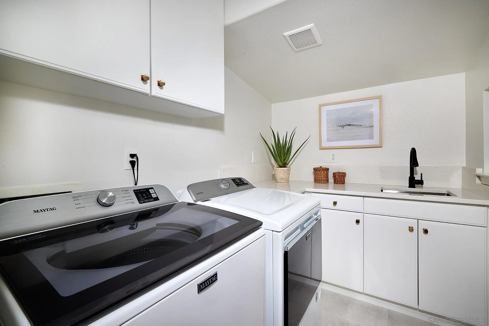 3501 Corte Romero Carlsbad, CA 92009 - Photo 27 of 48 a kitchen with a sink stove and white cabinets