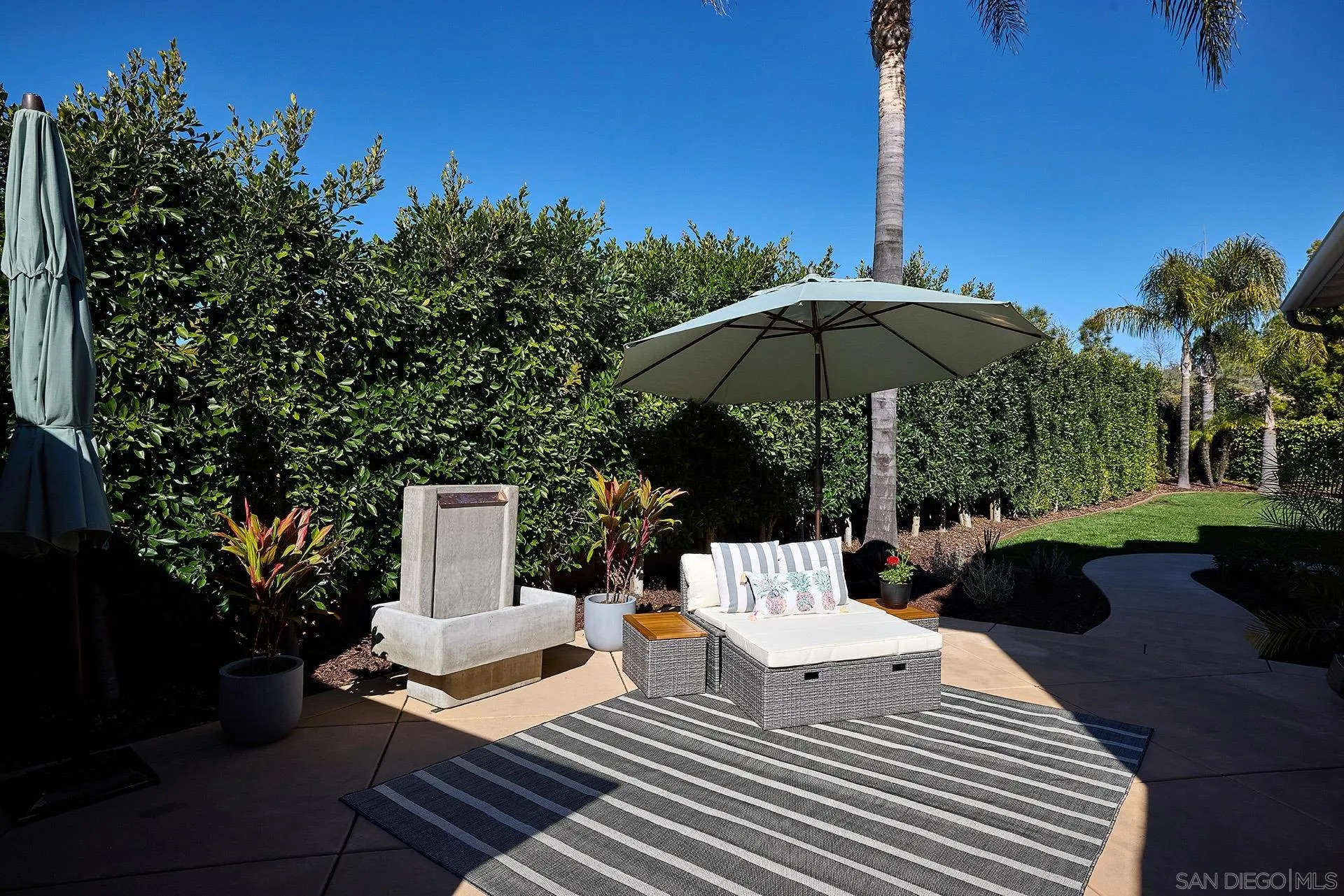 3501 Corte Romero Carlsbad, CA 92009 - Photo 33 of 48 a view of a roof deck with a table and chairs under an umbrella