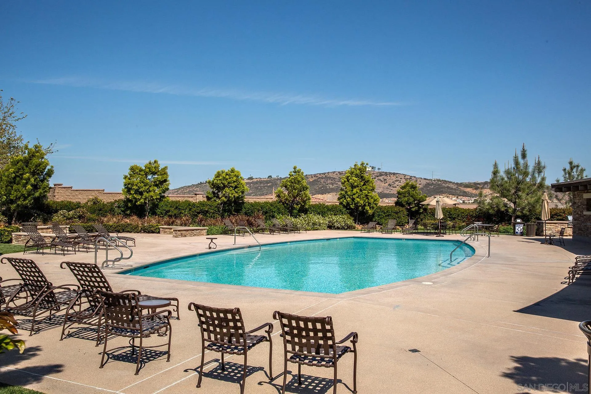 3501 Corte Romero Carlsbad, CA 92009 - Photo 47 of 48 a view of a swimming pool with lawn chairs