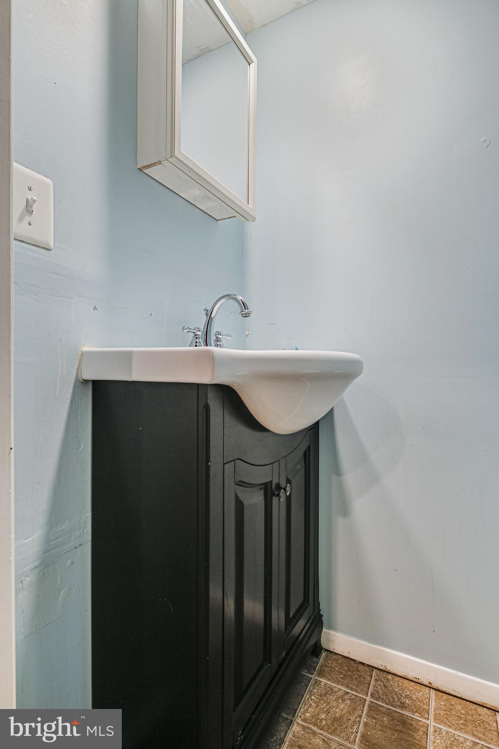 1027 Elm Road Baltimore, MD 21227 - Photo 22 of 36 a kitchen with a sink and cabinets