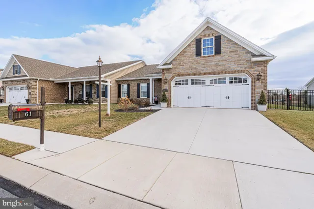 a front view of a house with parking space