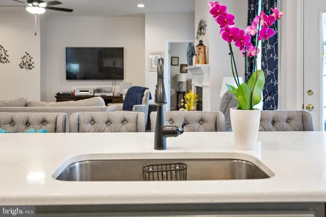 a kitchen with a table chairs sink and wooden floor