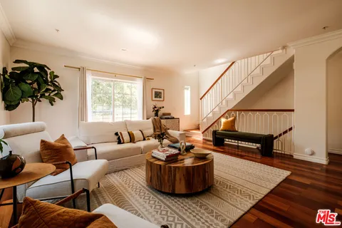 a living room with furniture and a hard wood floor