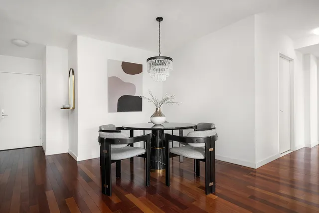 a living room with furniture a mirror and a large window