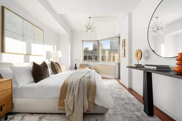 a bedroom with bed and a mirror