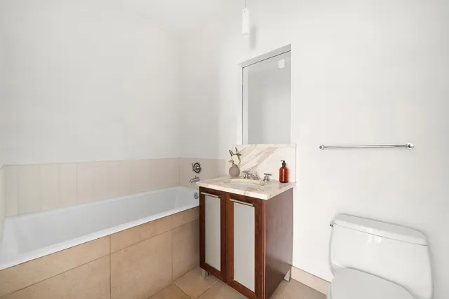 a living room with a bed furniture and a large window