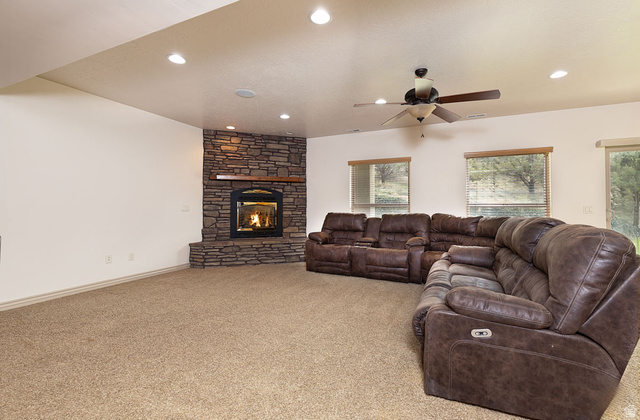 888 East Fiddlers Canyon Road Cedar City, UT 84721 - Photo 40 of 74 Carpeted living area with a ceiling fan, a fireplace, and recessed lighting