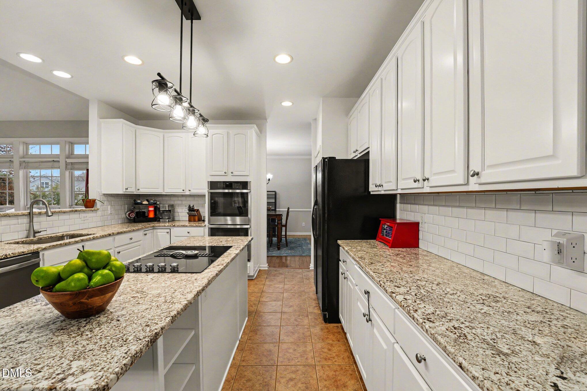 2505 Wyatt Lane Raleigh, NC 27614 - Photo 14 of 54 a kitchen with a stove a sink and a refrigerator