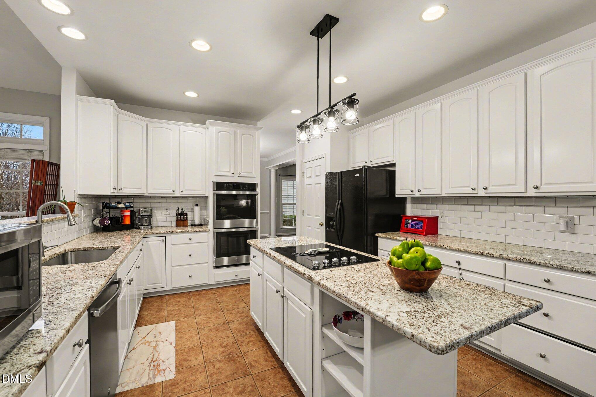 2505 Wyatt Lane Raleigh, NC 27614 - Photo 15 of 54 a kitchen with granite countertop stainless steel appliances sink stove microwave and cabinets