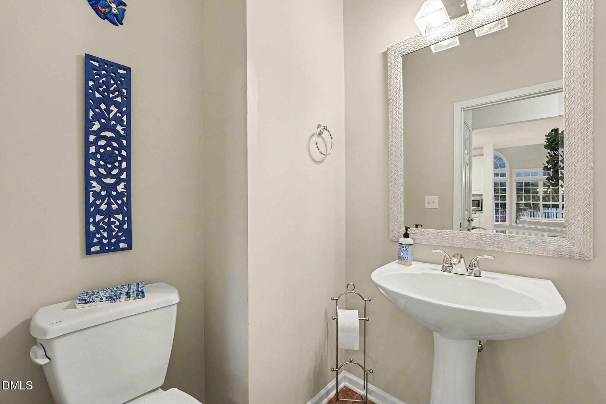 2505 Wyatt Lane Raleigh, NC 27614 - Photo 22 of 54 a bathroom with a toilet sink and mirror