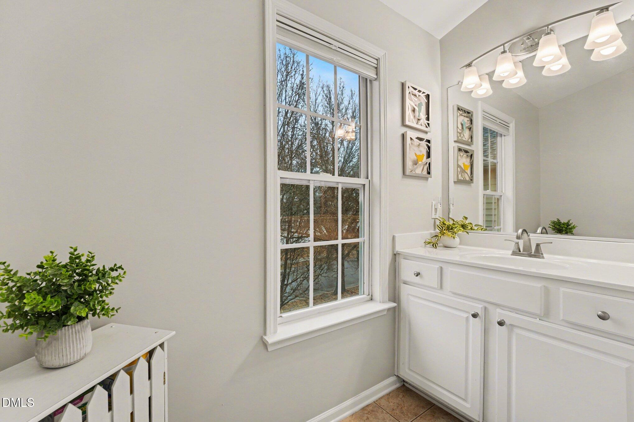 2505 Wyatt Lane Raleigh, NC 27614 - Photo 24 of 54 a bathroom with a sink mirror and a window