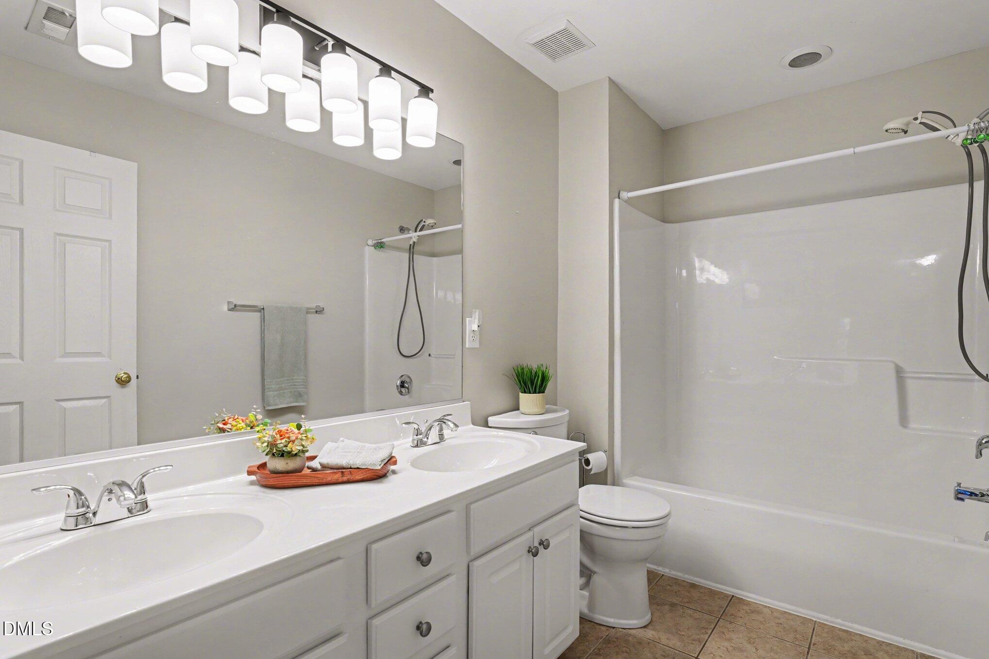 2505 Wyatt Lane Raleigh, NC 27614 - Photo 31 of 54 a bathroom with a double vanity sink toilet mirror and shower