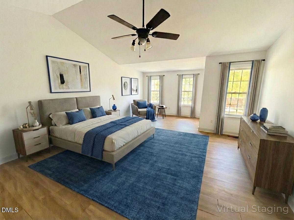 2505 Wyatt Lane Raleigh, NC 27614 - Photo 3 of 54 a spacious bedroom with a bed and a couch