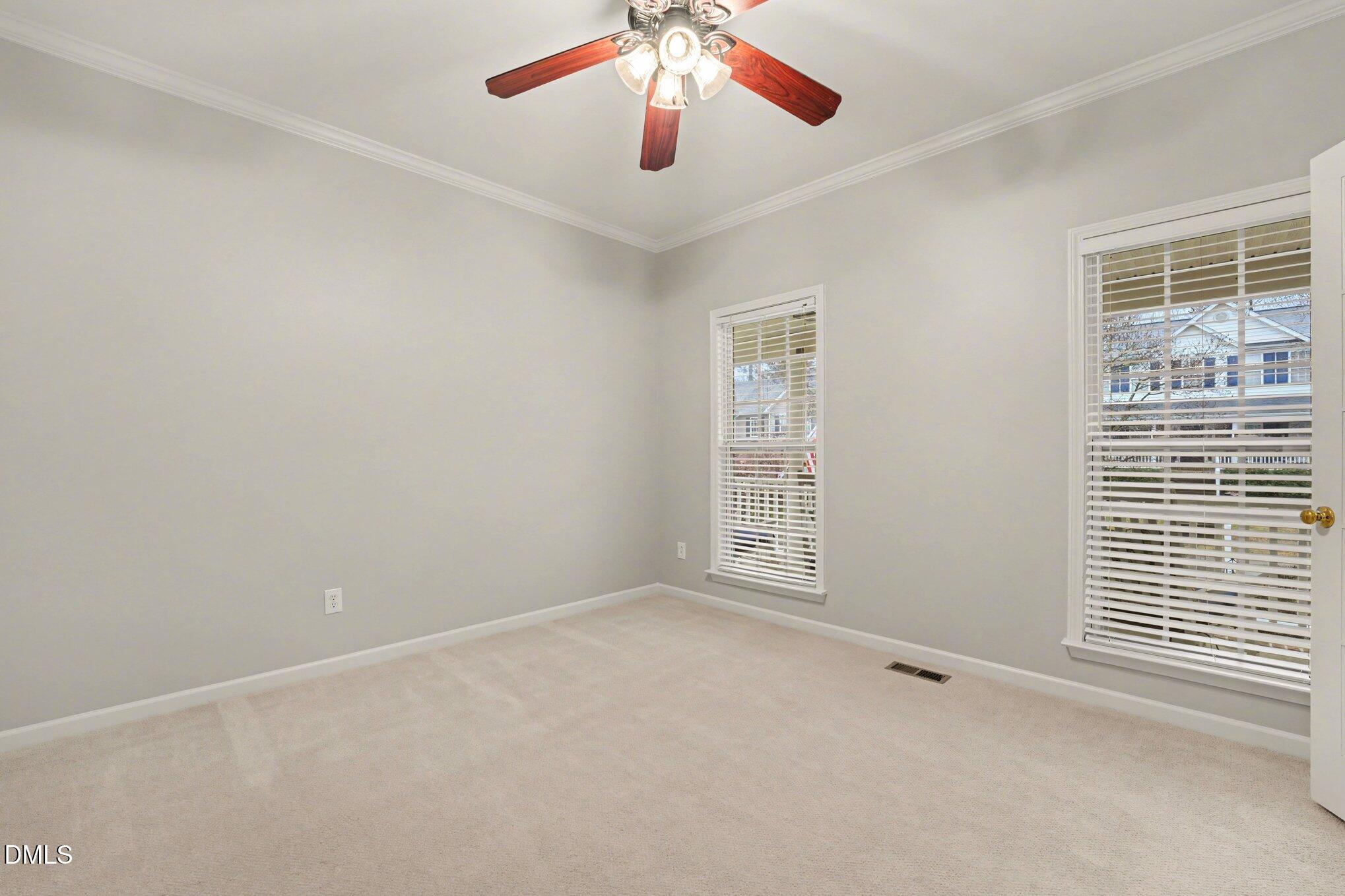 2505 Wyatt Lane Raleigh, NC 27614 - Photo 8 of 54 an empty room with windows and chandelier fan