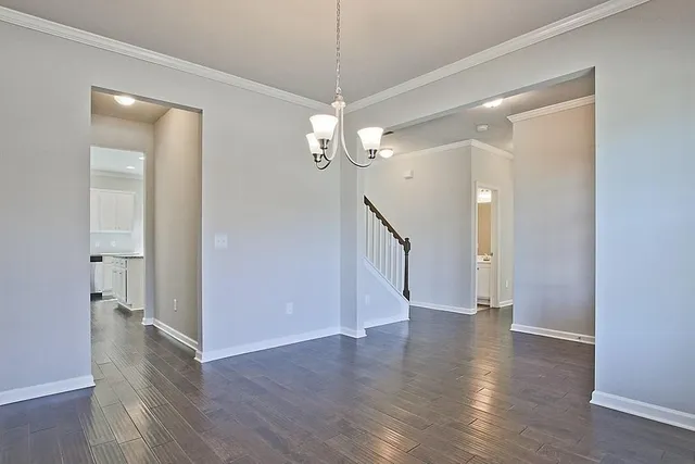 a view of a room with wooden floor and white walls