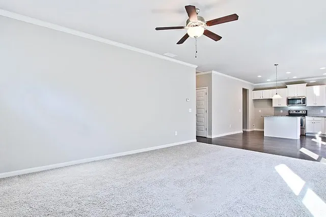 a view of a kitchen with a sink and a chandelier fan