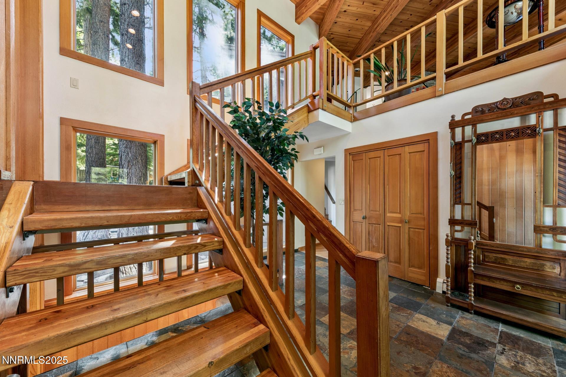 173 Hall Court Stateline, NV 89449 - Photo 21 of 32 a view of staircase with lots of frames on wall and a window