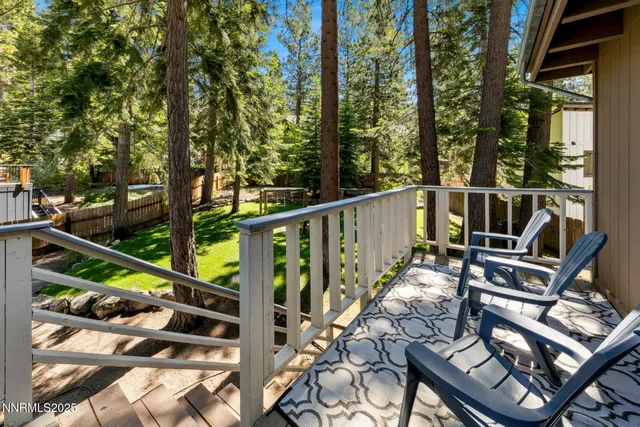 a view of deck with furniture and trees