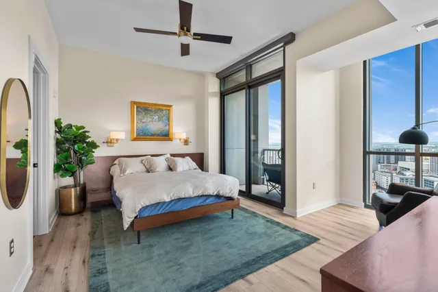 a bedroom with a bed lamp and dresser